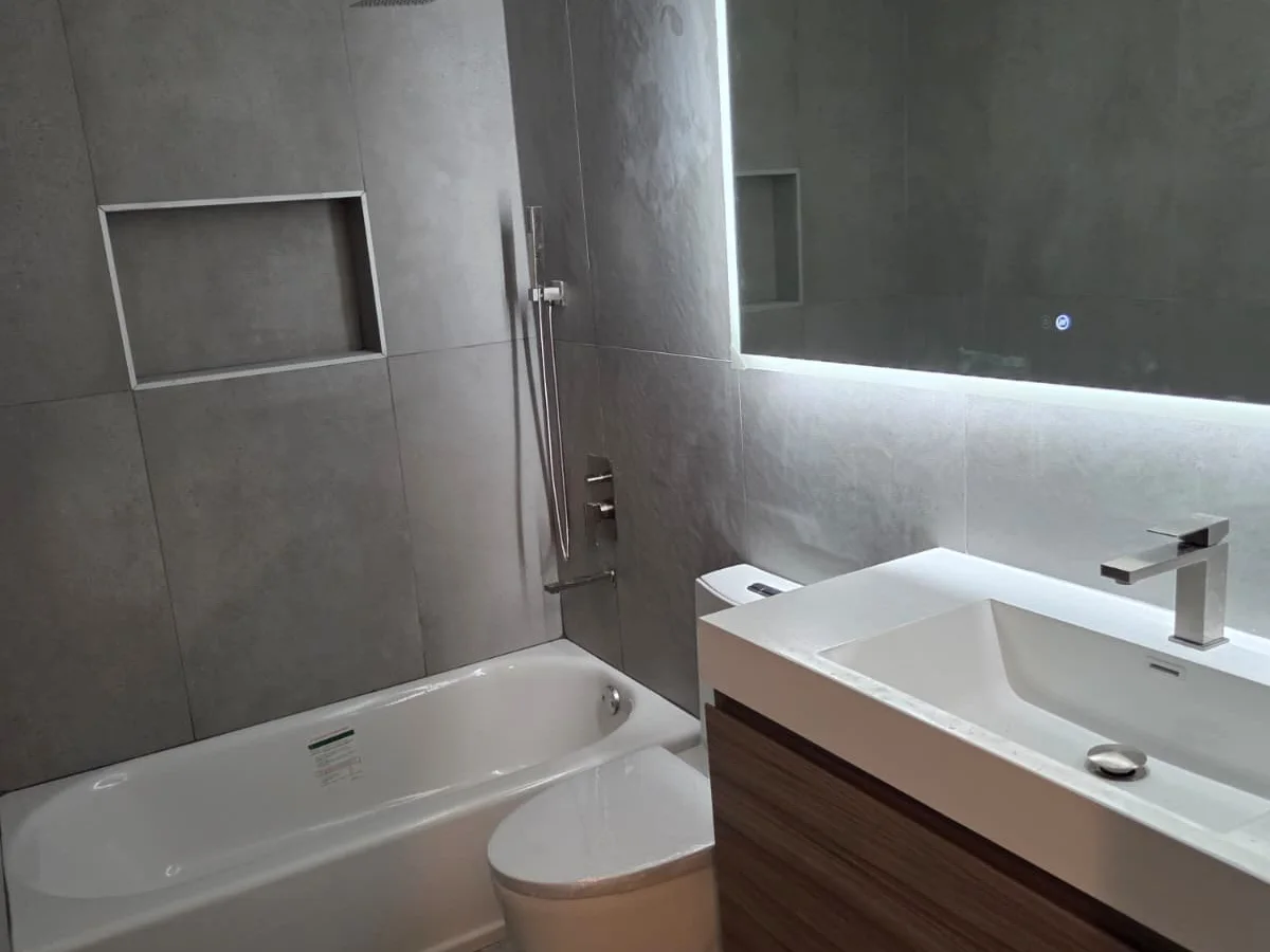 Modern remodeled bathroom with tile, vanity and tub