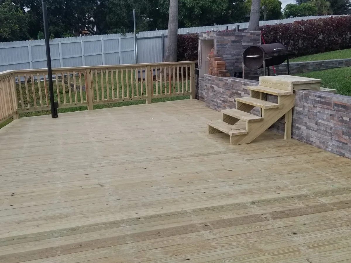 Wood deck with stairs and a stone base