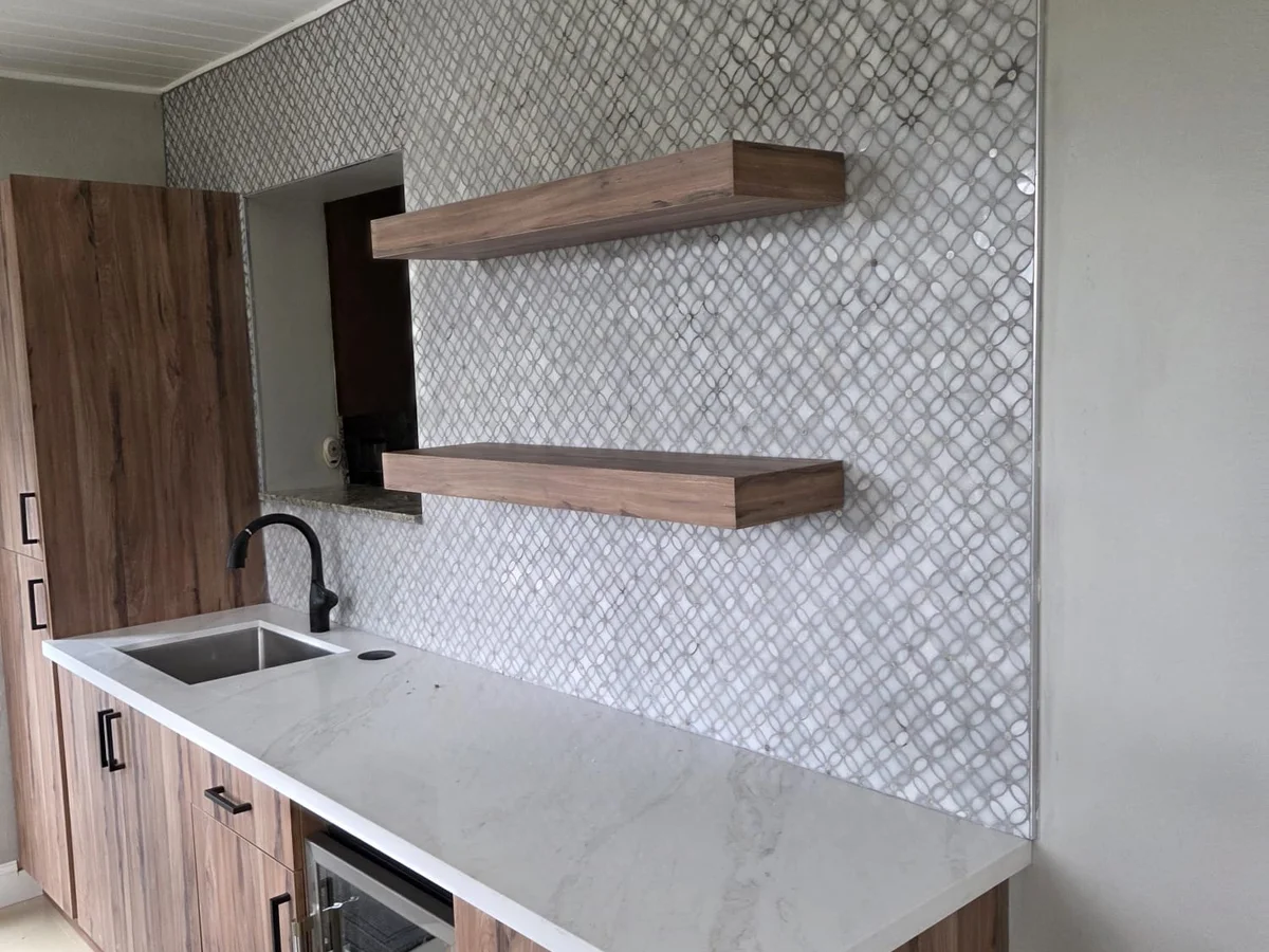 Remodeled kitchen with wood cabinets and tile backsplash