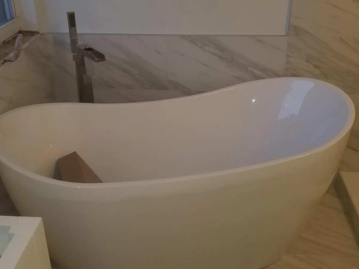 Freestanding soaking tub in a remodeled bathroom